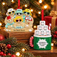 Personalized family of 6 Christmas ornaments featuring a beach-themed sand family and a hot cocoa mug with six marshmallow characters, surrounded by evergreen branches and warm Christmas lights.