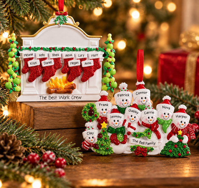 Personalized large family Christmas ornaments featuring a custom stocking fireplace ornament and a snowman family ornament, displayed with festive greenery and warm Christmas lights.