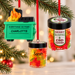 Personalized novelty and adult humor Christmas ornaments featuring a funny dumpster fire ornament and colorful gummy jar ornaments, hanging on a Christmas tree with soft holiday lights.