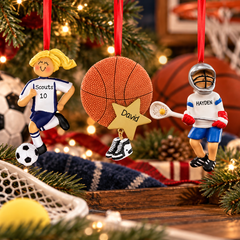 Personalized sports Christmas ornaments featuring a soccer player, basketball ornament, and lacrosse player displayed with festive Christmas decorations.