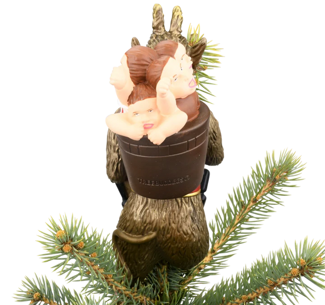 Krampus Christmas tree topper featuring a horned folklore figure with a long red tongue, black chain, branches, and child on his back.