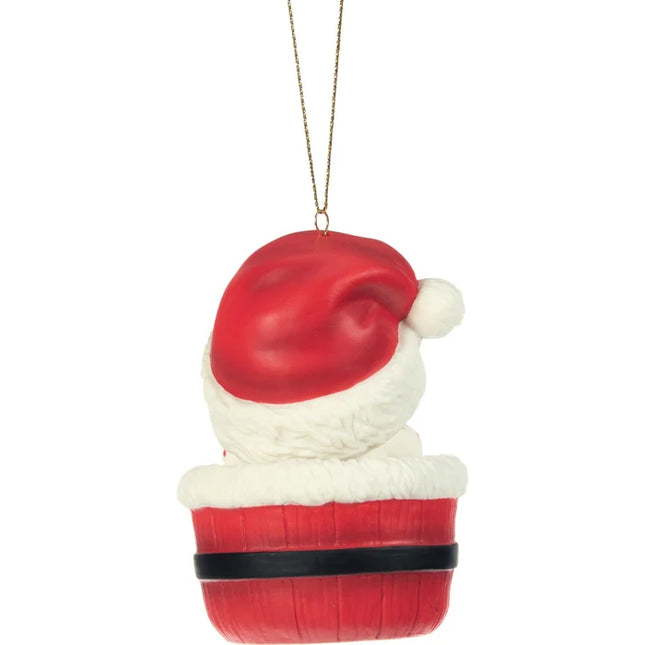 Precious Moments Baby's 1st Christmas ornament featuring a baby wearing a Santa hat and nestled inside a festive red Santa-inspired basket.