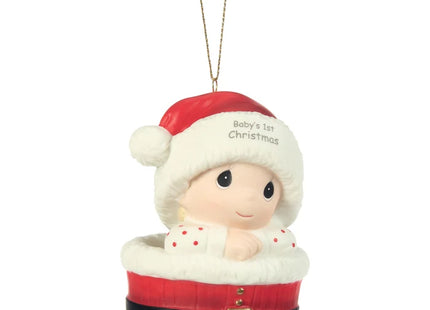 Precious Moments Baby's 1st Christmas ornament featuring a baby wearing a Santa hat and nestled inside a festive red Santa-inspired basket.