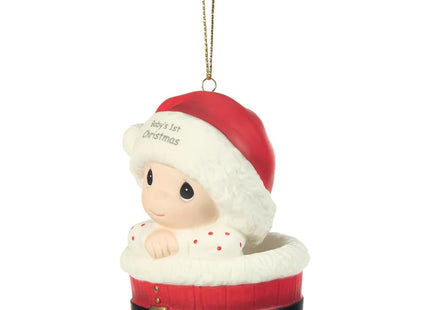 Precious Moments Baby's 1st Christmas ornament featuring a baby wearing a Santa hat and nestled inside a festive red Santa-inspired basket.