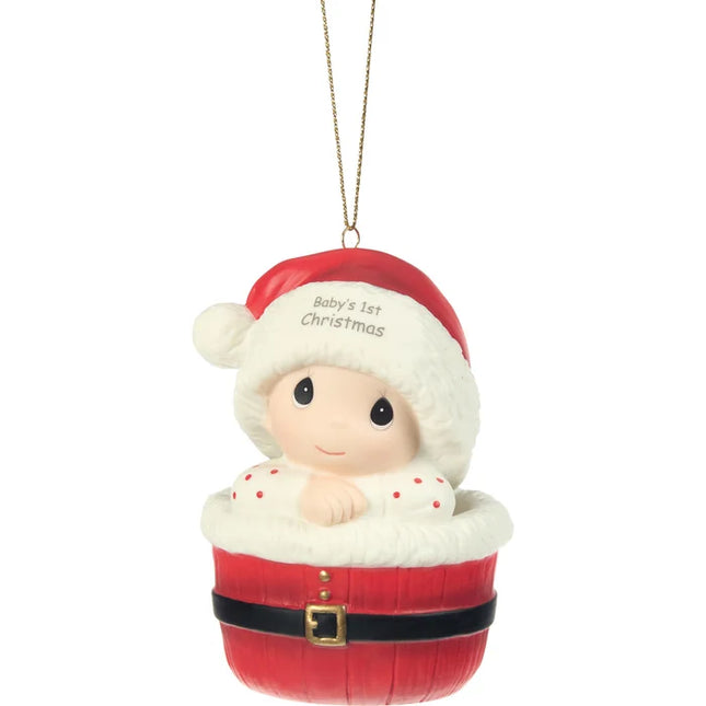 Precious Moments Baby's 1st Christmas ornament featuring a baby wearing a Santa hat and nestled inside a festive red Santa-inspired basket.