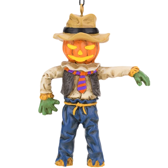 Pumpkin head scarecrow Halloween ornament featuring a jack-o'-lantern face, rustic hat, striped orange and purple tie, blue pants, and green gloves.