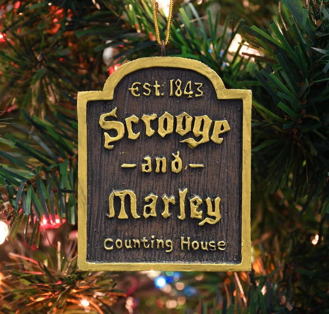Scrooge and Marley Counting House Christmas ornament with dark wood-look finish, gold lettering, and Est. 1843 detail.