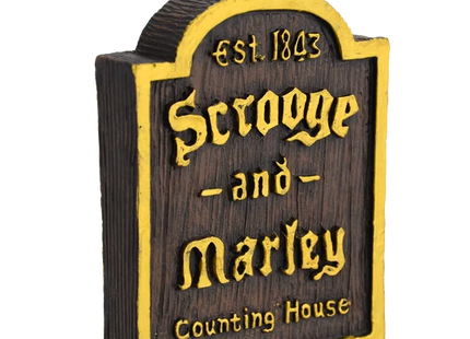 Scrooge and Marley Counting House Christmas ornament with dark wood-look finish, gold lettering, and Est. 1843 detail.