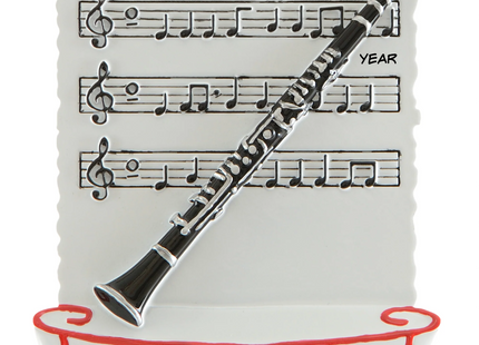 Personalized clarinet Christmas ornament with name and year featuring a black and silver clarinet on sheet music.

