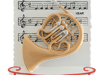 Personalized French horn Christmas ornament with name and year featuring a gold French horn and sheet music background.
