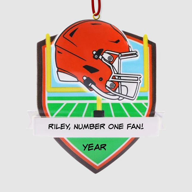 Personalized Cleveland Browns football helmet Christmas ornament with custom name and optional year on a football field background.
