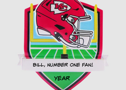 Personalized Kansas City Chiefs football helmet Christmas ornament with custom name and optional year on a football field background.