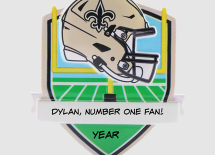 Personalized New Orleans Saints football helmet Christmas ornament with custom name and optional year on a football field background.