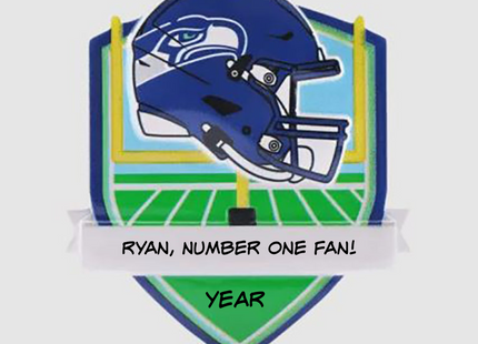 Personalized Seattle Seahawks helmet Christmas ornament featuring a football field background and custom name banner.