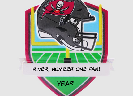 Personalized Tampa Bay Buccaneers helmet Christmas ornament featuring a football field background and custom name banner.