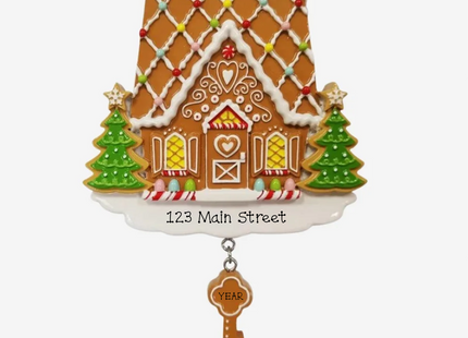 Personalized gingerbread house Christmas ornament with custom street address, year, Christmas trees and dangling house key.