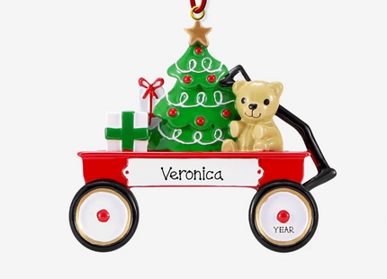 Personalized Christmas wagon ornament featuring a festive red wagon with a Christmas tree, teddy bear, custom name, and year.
