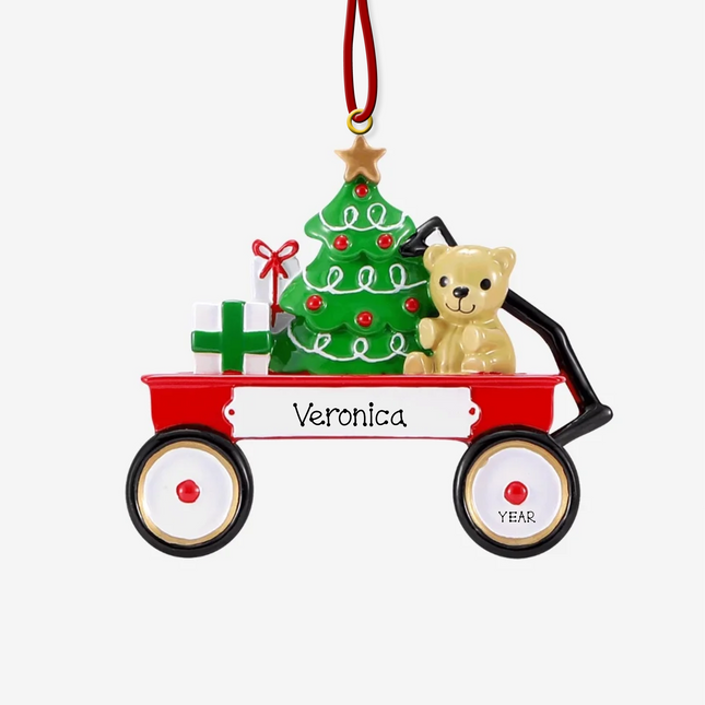 Personalized Christmas wagon ornament featuring a festive red wagon with a Christmas tree, teddy bear, custom name, and year.
