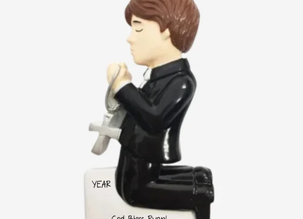 Personalized boy First Communion Christmas ornament with child kneeling in prayer holding a cross, custom name and year.