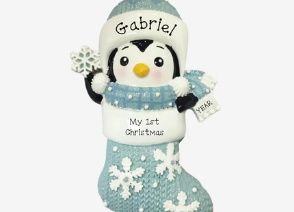 Personalized baby's first Christmas penguin stocking ornament in blue with snowflakes, custom baby name and year.