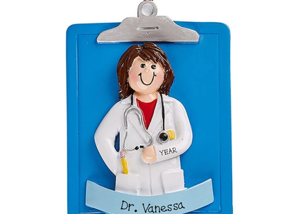 Personalized female doctor Christmas ornament with white coat, stethoscope, blue clipboard, name banner and year