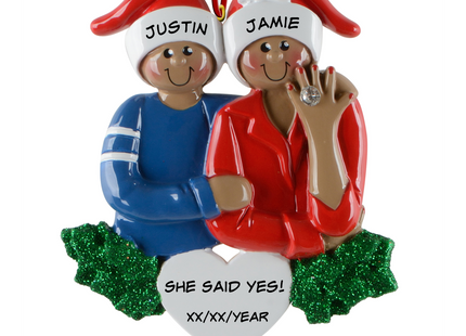 Personalized African American She Said Yes engagement Christmas ornament with two names and engagement date featuring a couple in Santa hats and an engagement ring.