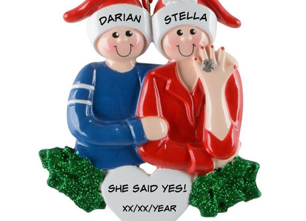 Personalized She Said Yes engagement Christmas ornament with two names and engagement date featuring a couple in Santa hats and an engagement ring.