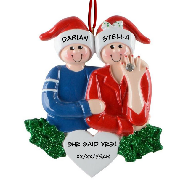 Personalized She Said Yes engagement Christmas ornament with two names and engagement date featuring a couple in Santa hats and an engagement ring.