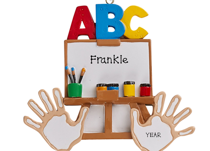 Personalized preschool art easel Christmas ornament with custom name and year featuring ABC letters, paintbrushes, paint, and handprints.