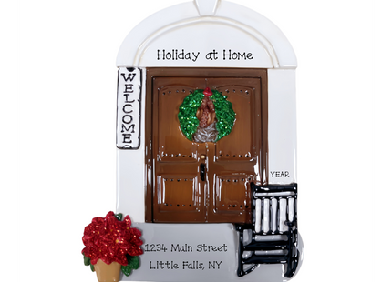 Personalized front door house Christmas ornament with custom message, address, and year featuring a holiday wreath, rocking chair, poinsettia, and welcome sign.