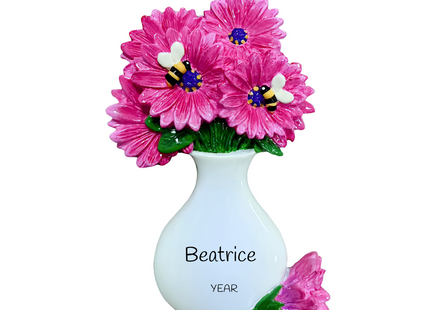 Personalized pink daisy bouquet Christmas ornament with custom name and year featuring vibrant pink daisies in a white vase with decorative bees.