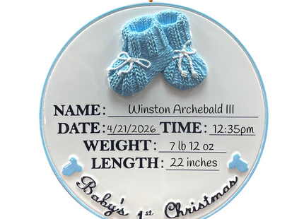 Personalized Baby's First Christmas ornament with blue baby booties featuring custom name, birth date, birth time, birth weight, birth length, and year.