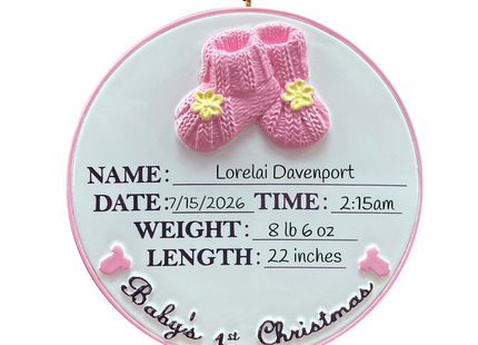 Personalized Baby's First Christmas ornament with pink baby booties featuring custom name, birth date, birth time, birth weight, birth length, and year.