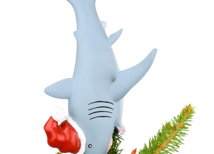 Gray shark Christmas tree topper diving headfirst into a Christmas tree while wearing a red and white Santa hat.
