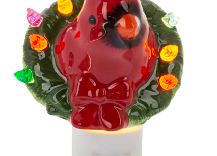 Christmas cardinal night light featuring a bright red cardinal surrounded by a green wreath with colorful holiday lights.