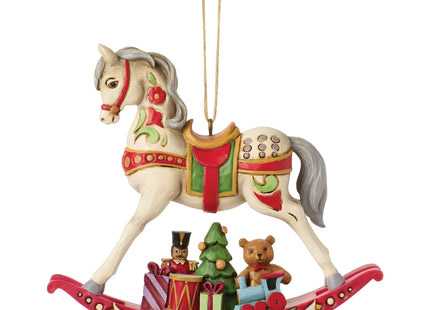 Traditional rocking horse Christmas ornament featuring a teddy bear, toy train, nutcracker, Christmas tree, and wrapped presents.